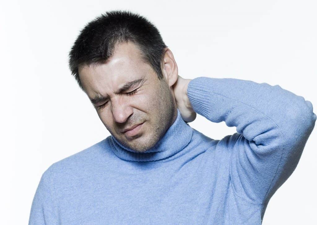 Ein Mann mit Nackenschmerzen sucht Linderung durch Sportosteopathie.